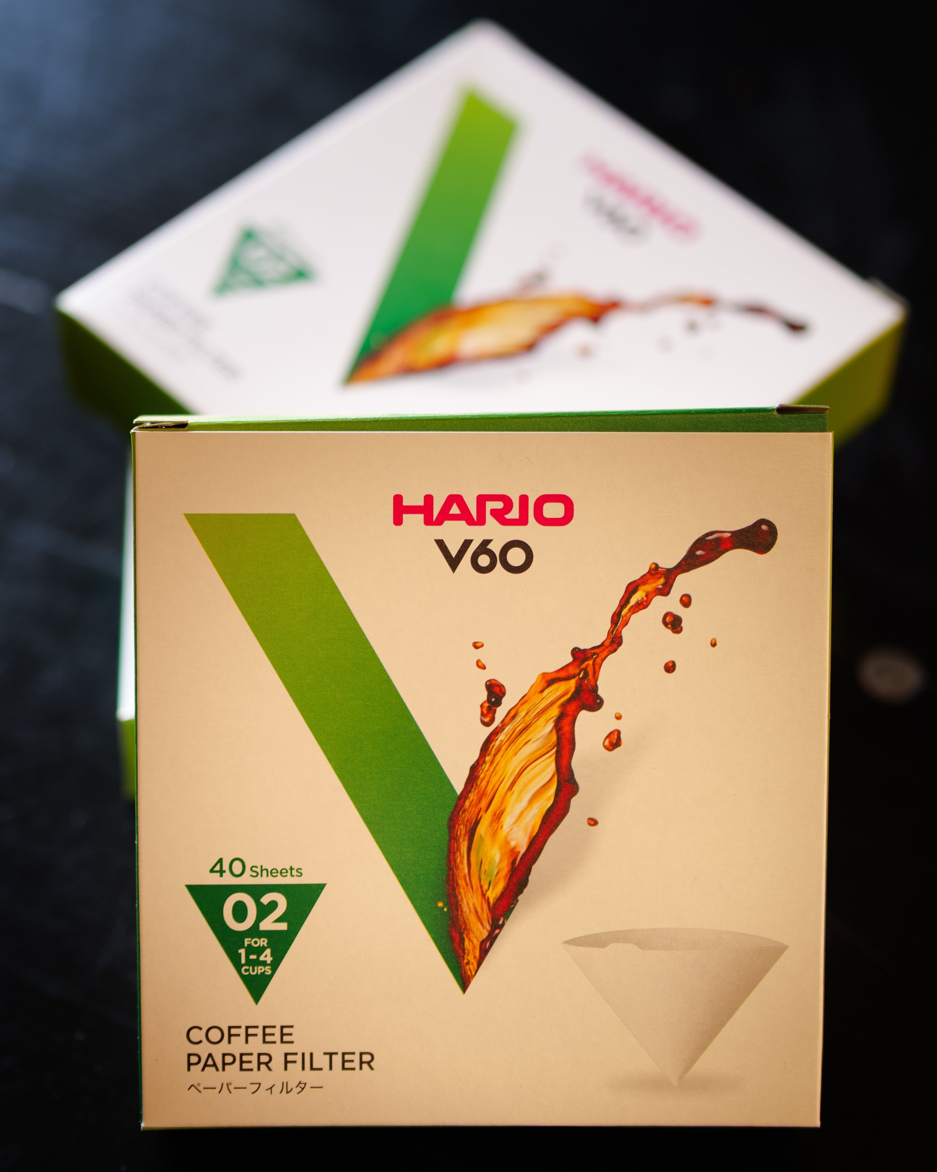 Hario V60 coffee paper filter box on a dark textured surface