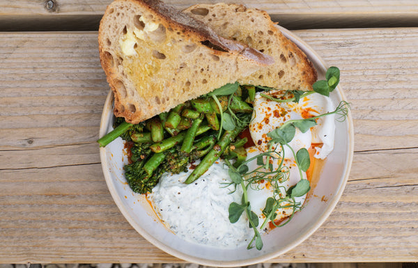 Turkish Eggs: poached eggs on garlic labneh, seasonal greens, aleppo pepper butter and toasted sourdough for mopping.