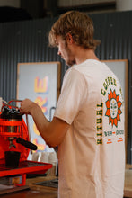 Load image into Gallery viewer, A person wearing the Ritual Coffee branded t-shirt making a coffee.