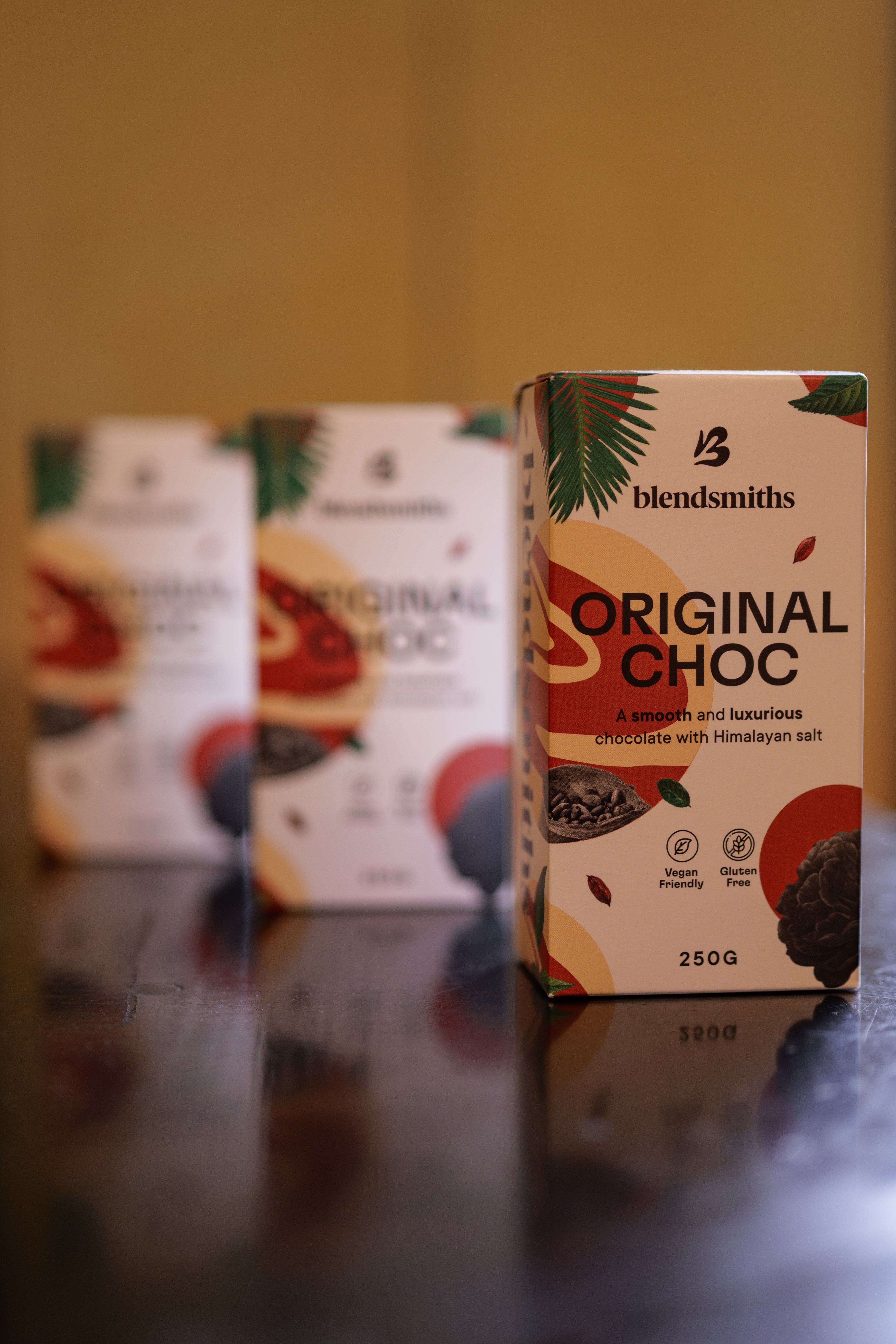 Blendsmiths Original Choc packaging on a reflective surface with a blurred background